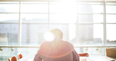 Man at Office Desk in Front of Window